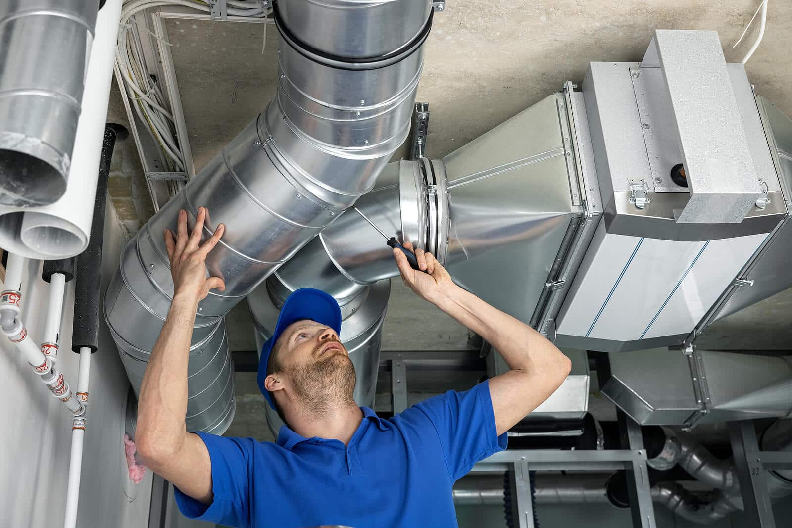 HVAC technician inspecting and repairing air ducts in San Fernando