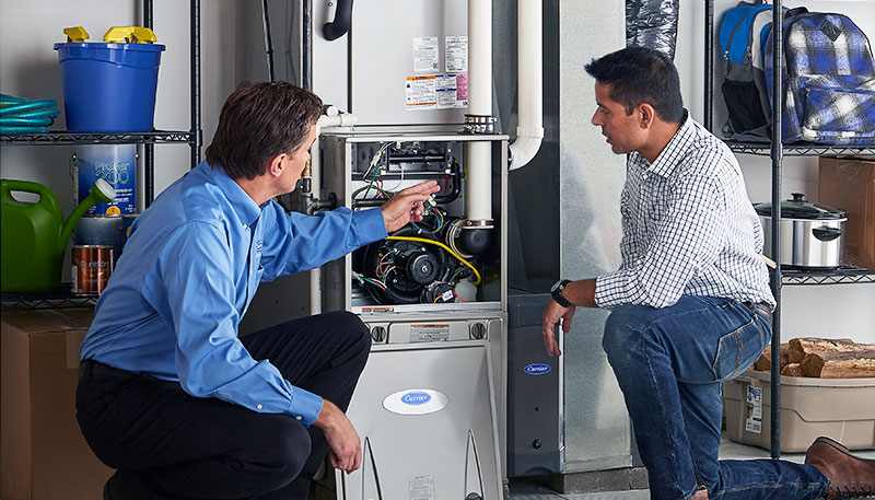 Technician evaluating a furnace for repair or replacement in San Fernando