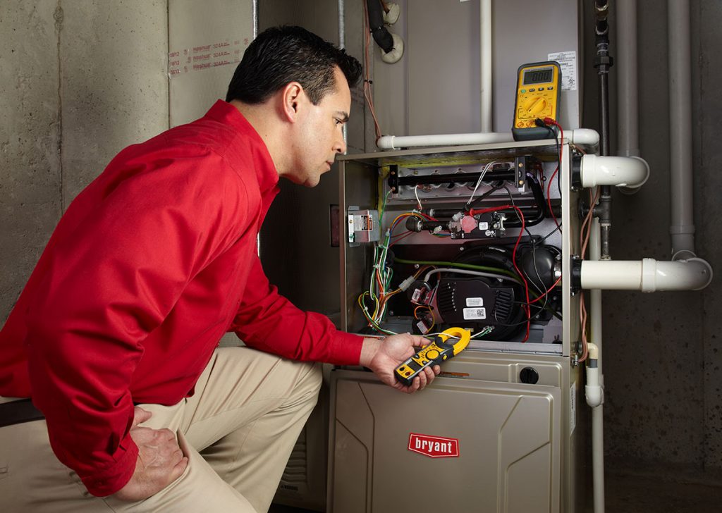 Heating technician diagnosing a furnace repair in San Fernando