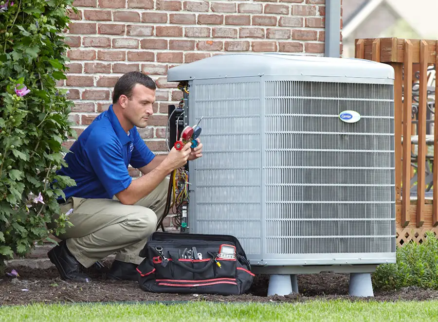 HVAC technician inspecting an outdoor AC unit in San Fernando