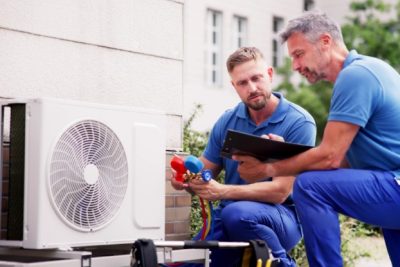 Outdoor AC Installation San Fernando HVAC technicians installing an outdoor air conditioning unit in San Fernando